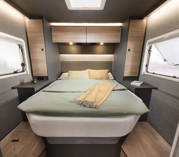 The Grand Tourer bedroom, made up with hotel-quality linen beneath a skylight