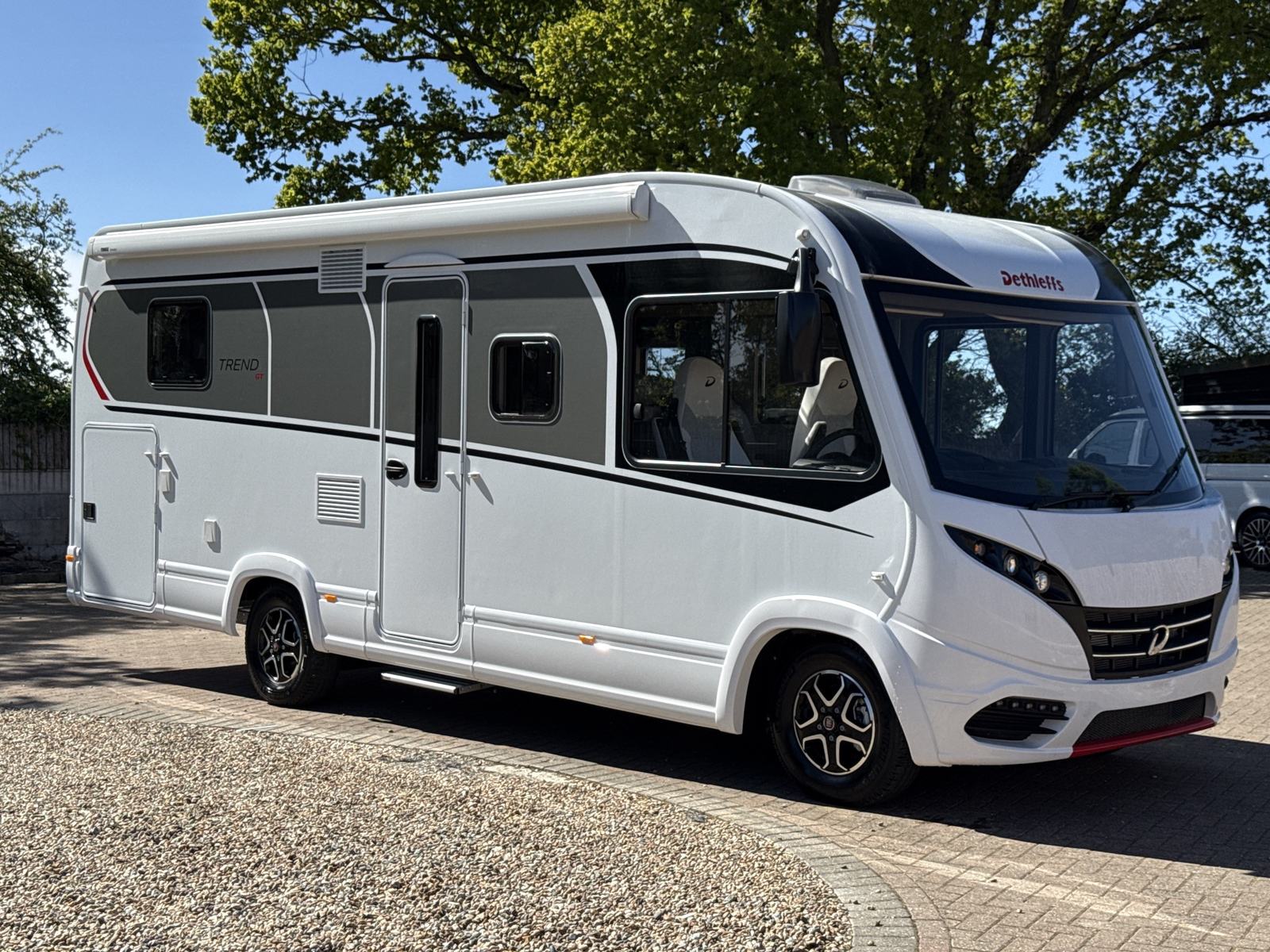 The Blazing Red Grand Tourer luxury RV, white with grey and red detailing