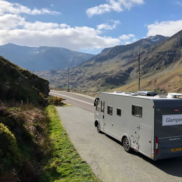 A-Class luxury Glamper motorhome parked on a mountain pass road