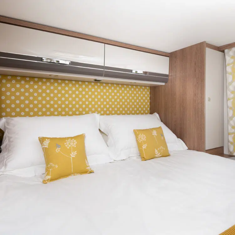 Super-king bed made up with white hotel linen inside the Glamper