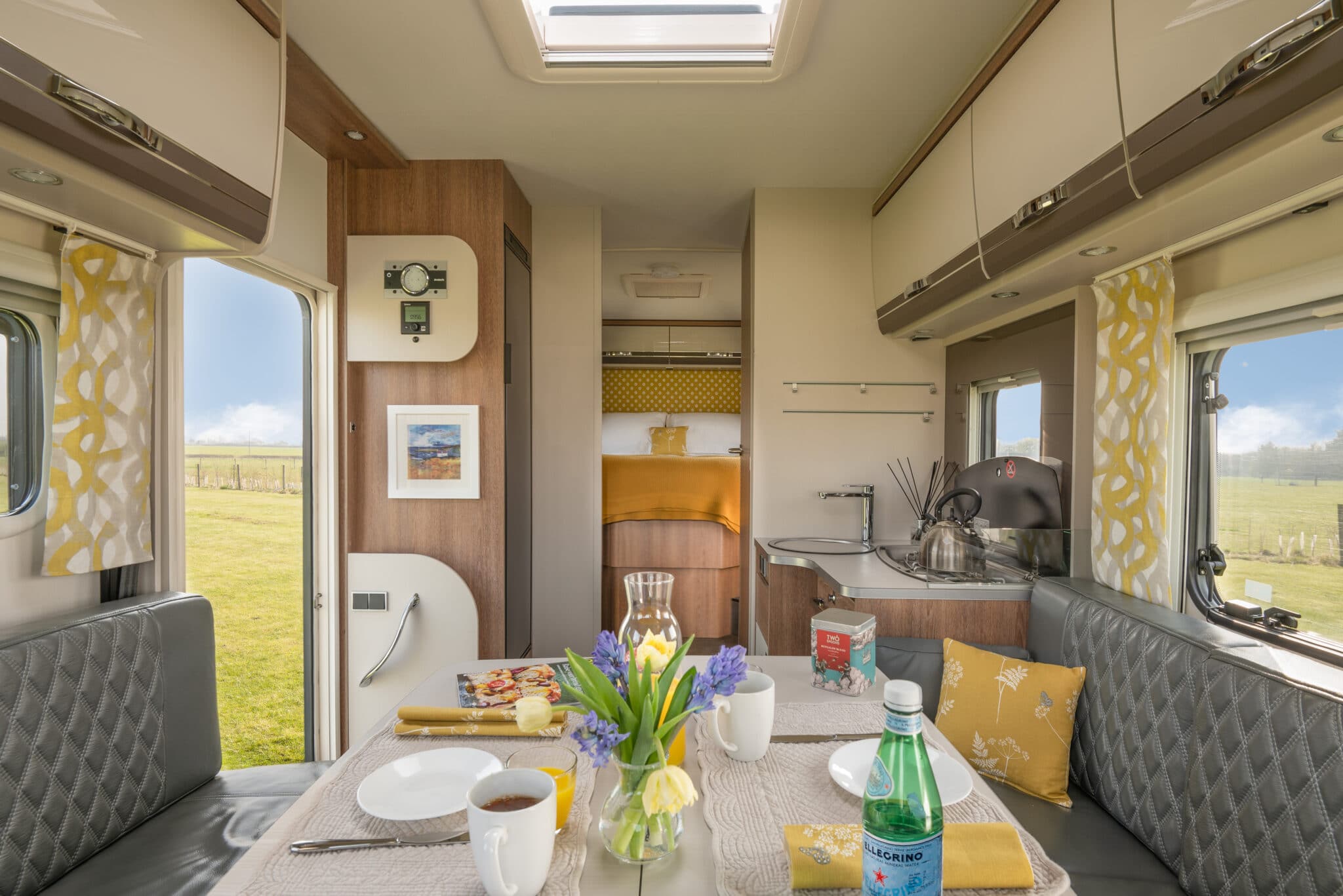 Glamper interior lounge and kitchen laid for breakfast